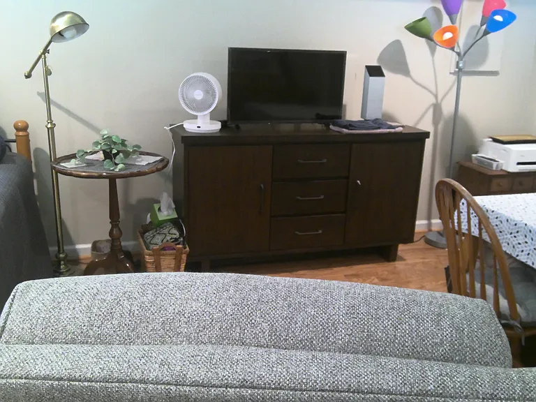 Living area; kitchen table off to right. Door to water closet off to right. Xfinity top-tier T.V. included with rental.