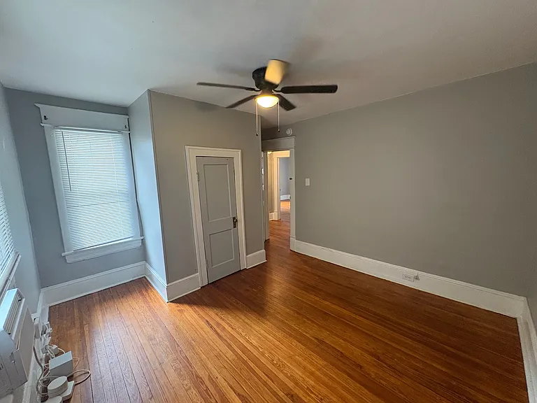 Second Bedroom w/ Designer Ceiling Fan and Newly Refinished Hardwood Floors. Newly Installed Closet Door to be Painted White.