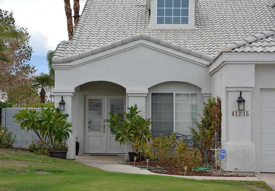 a welcoming entry with rose garden