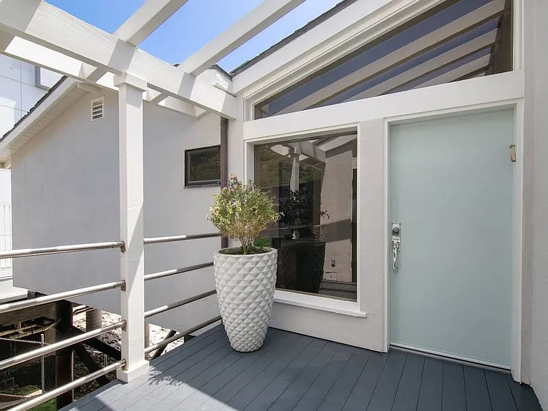 Entryway in between the first door and the front door that leads to the villa.