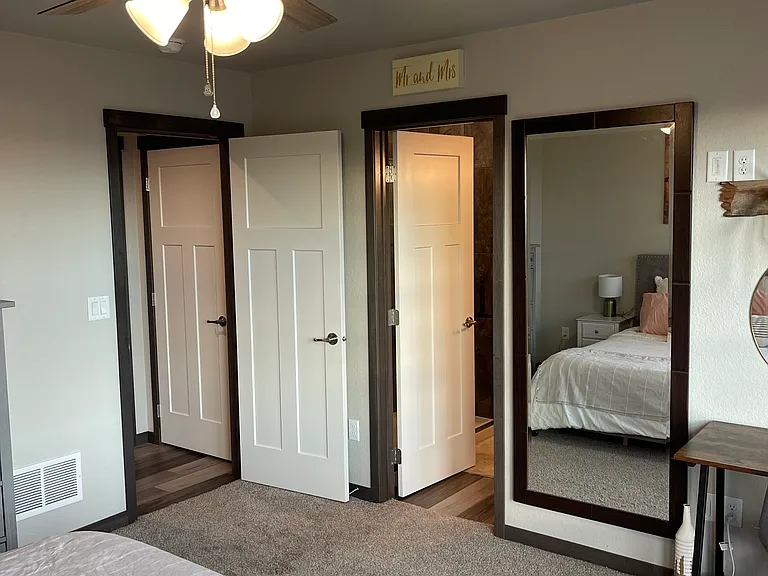 Primary bedroom with ensuite door pictured