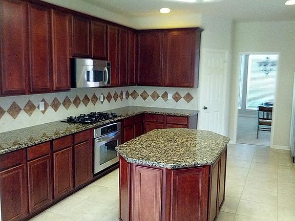 Kitchen with stainless appliances, huge island and a true walk-in pantry