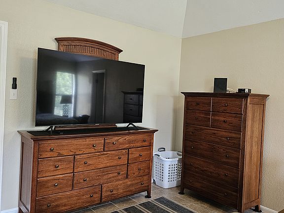 Master bedroom clothes storage and entertainment.