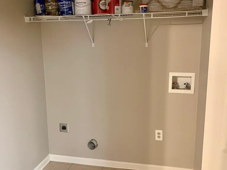 laundry room with double doors in the hallway