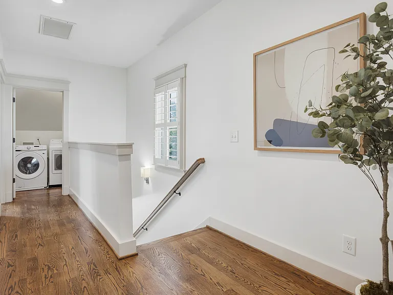 Find the laundry room at the end of hallway on the second floor.