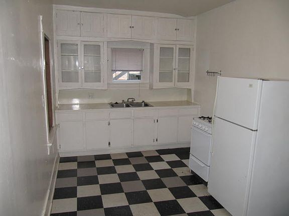 Large kitchen area with floor to ceiling cabinets