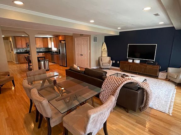 West elm dining table, article couch, Crate and barrel media table, 65" Samsung Frame TV, Pier 1 chairs
