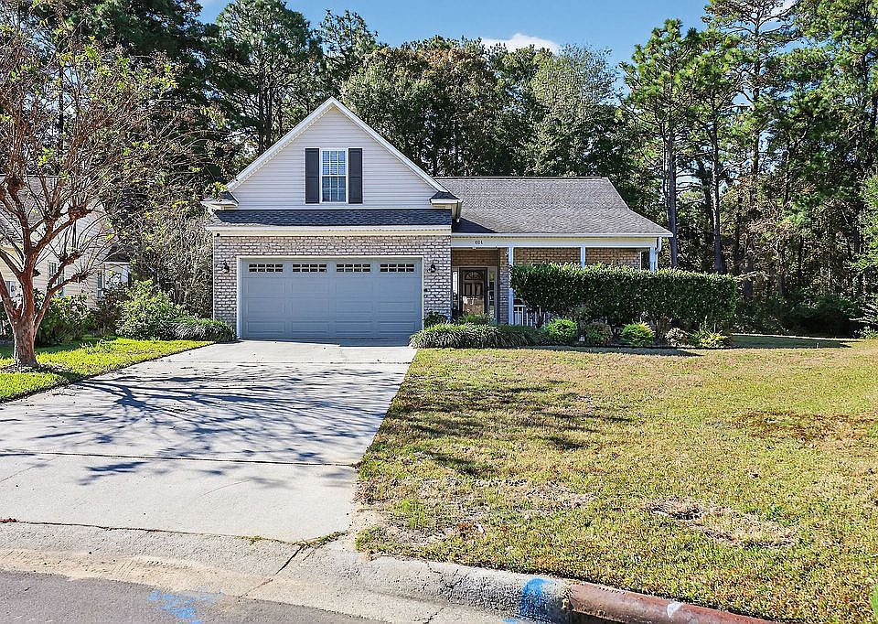 Resting on a wooded, .6 acre