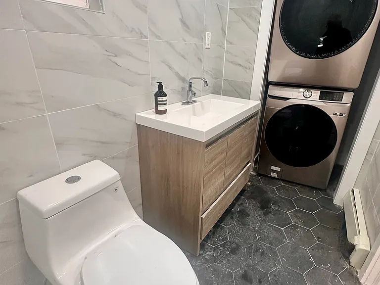 Modern designer bathroom with floor-to-ceiling Italian tile.