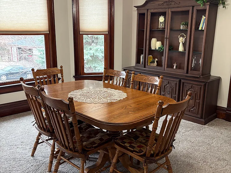 Dining room has expandable solid oak table set, china hutch, and new window treatments.