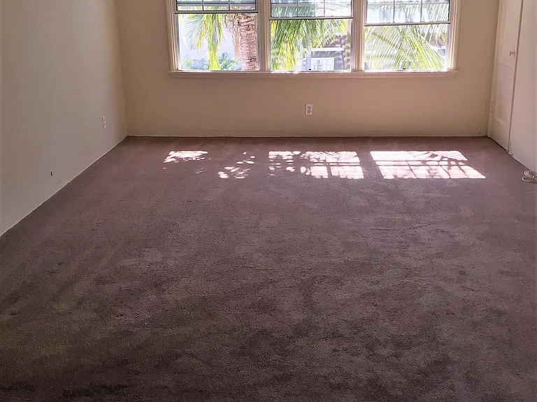 Large upstairs unit living space with pool view.