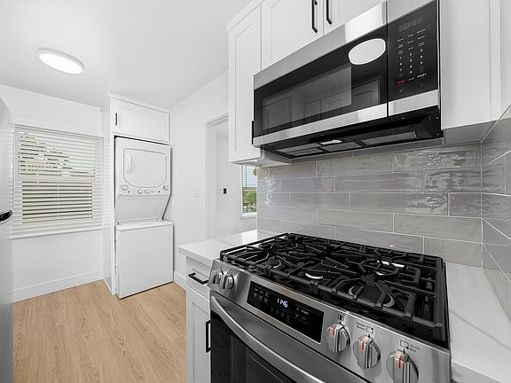 Built In Microwave Above Stove. Stack Washer and Dryer.
