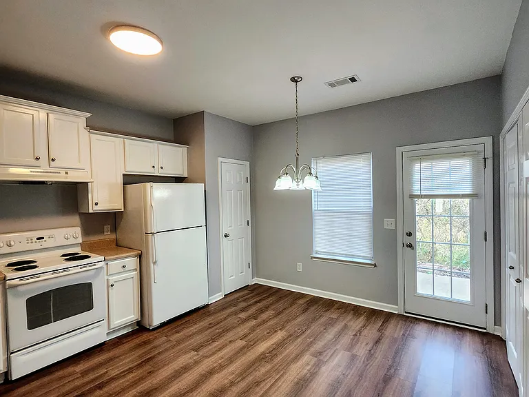 Kitchen showing back door that leads to the outside patio