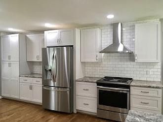 HOUSE: Kitchen with new cabinets, new fridge, new wall tile, new granite countertop, new stove vent and plenty of storage.