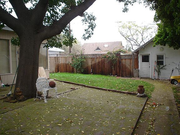 Large fenced lot with parking in rear.