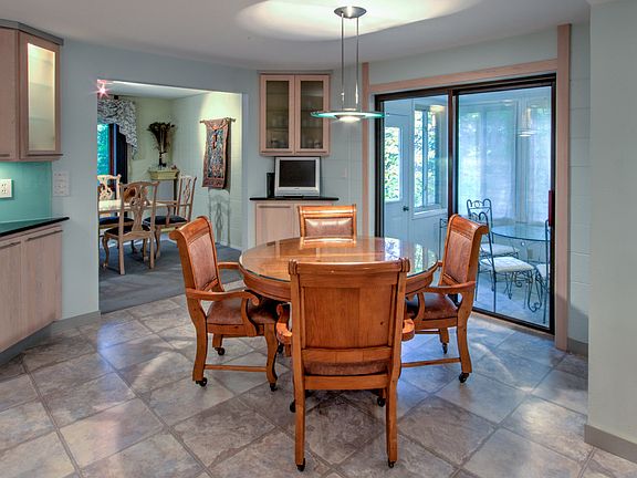 Large eat in kitchen with sliding door to 3 season room.  also features a corner built in.