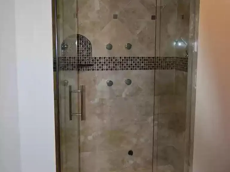 Steam shower in master bath with body spray, hand held and rainshower. Bench for two
