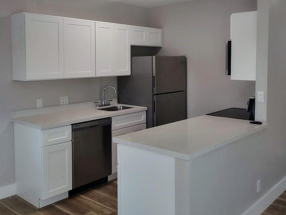 brand new kitchen with designer shaker-style cabinetry and stainless appliances