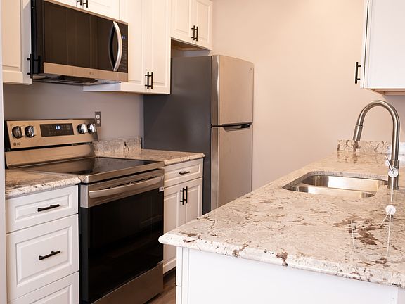 Kitchen with new appliances and granite counter tops.