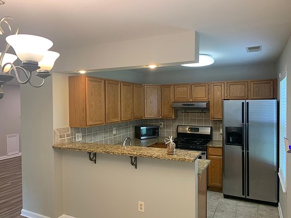 Kitchen with stainless appliances and granite counters.