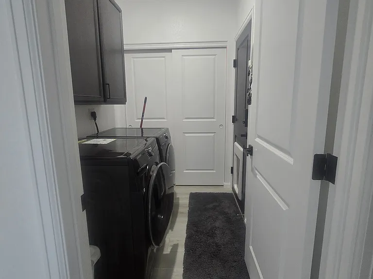Laundry Room & Furnace Room. Man Door and dog door leading into the 2 Car Garage (Washer and Dryer not Included)