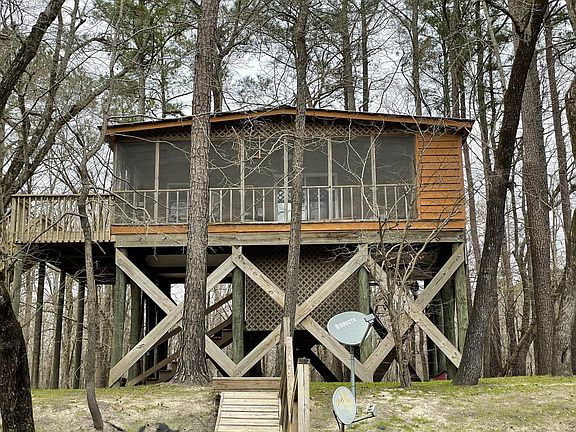 House and screened porch view from the river.