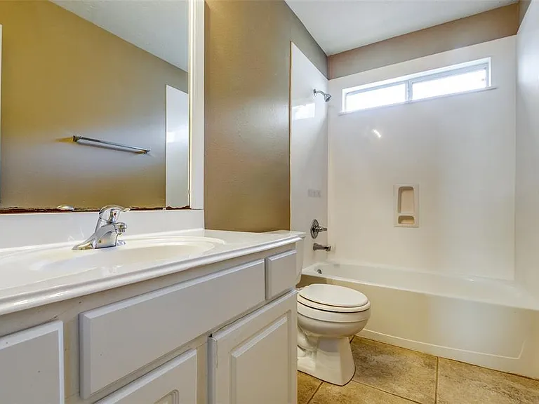 The second bathroom has large vanity, toilet, tub and shower combo.