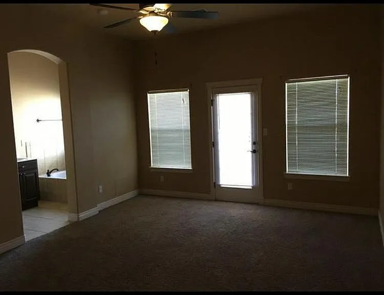 Master bedroom with door access to back yard/patio.