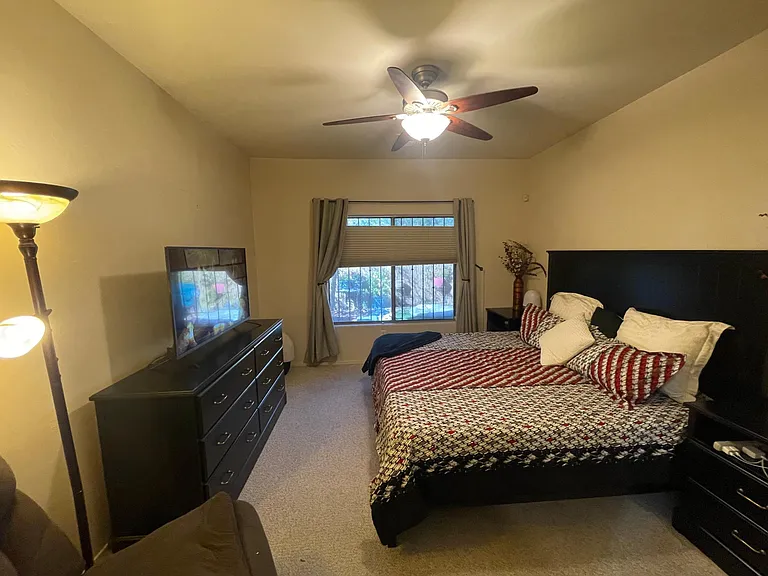 View from master bathroom hall to master bedroom

Ceiling fan