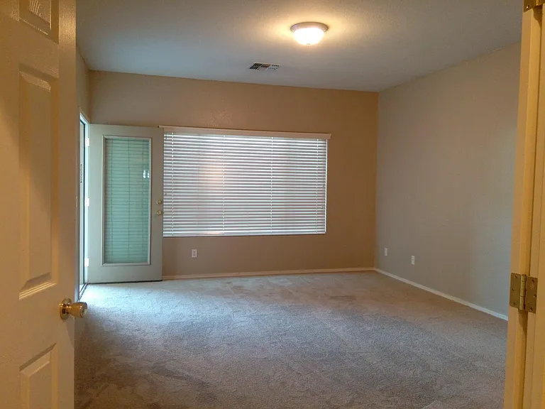 master bedroom with side door to the backyard patio