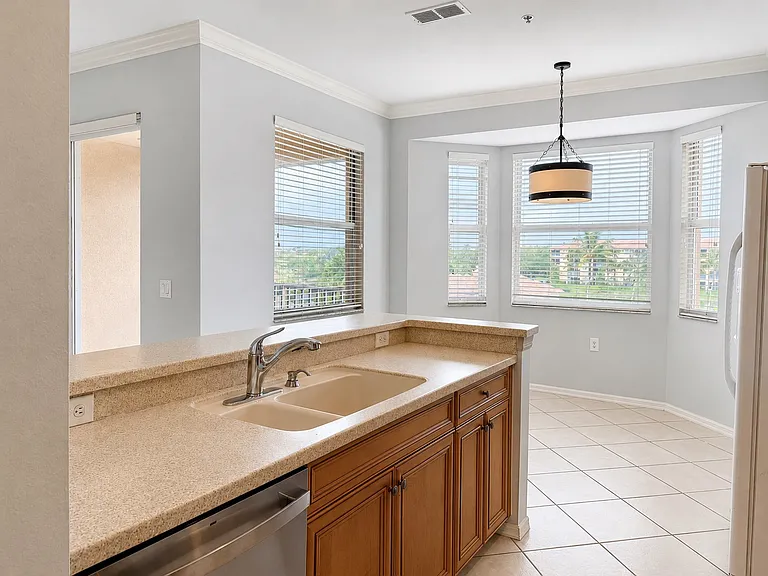 Bright dining area and kitchen with large windows and lake views