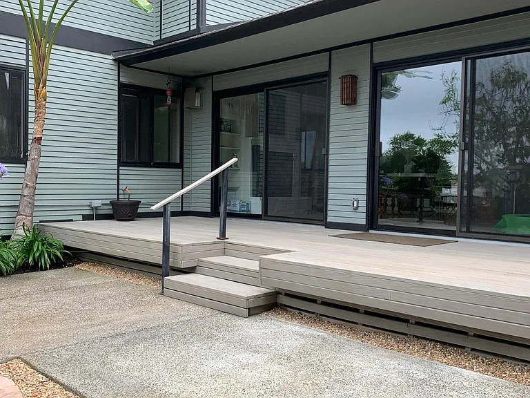 Two large sliding glass doors to bring in an abundance of natural light to the open concept casita. A wall in common between the land lord and the Casita is shared. In this photo you can more clearly see how the Casita has its own roof but is sharing a wa