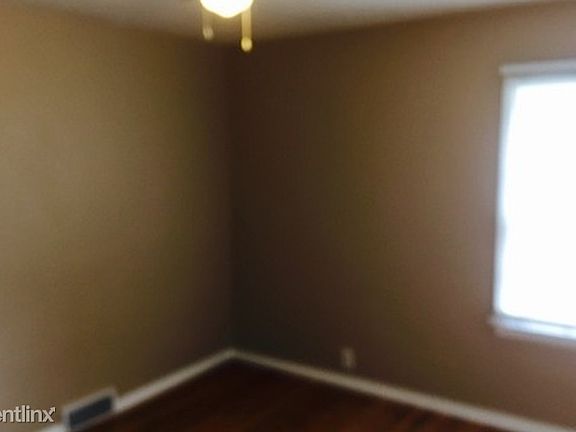 cozy upstairs bedroom facing backyard