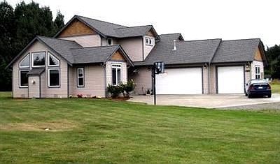 Front Elevation Spacious home on 1 acre with 3 car garage and room to roam.