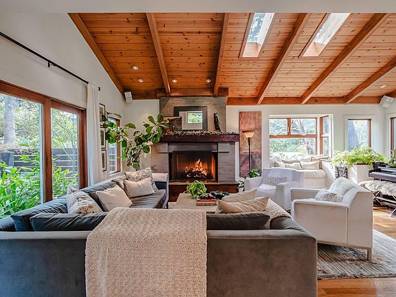 Light filled great room with views of nature and hillsides, and extended living space through sliding doors to a large deck