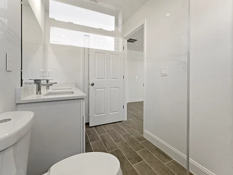 Master bathroom with his/her sinks and walk-in shower