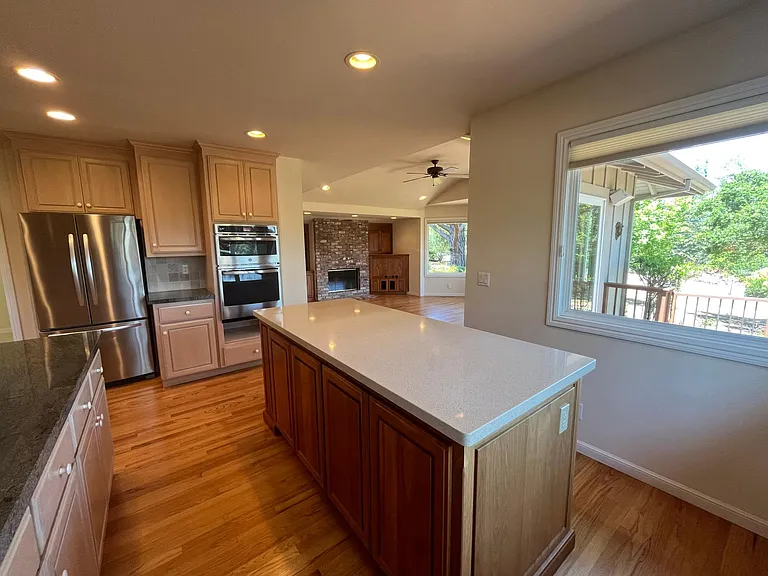 Wonderful gourmet kitchen is equipped with stainless steel appliances, quartz countertop, a lengthy island and soft-close cabinetry.