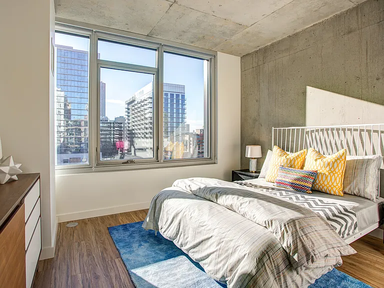 Wake up to sunshine and skyline views in this cozy, modern bedroom.
