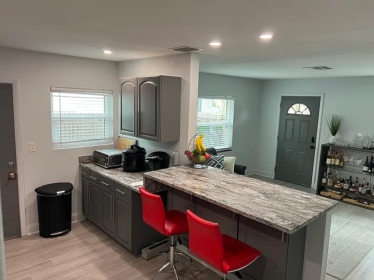 Kitchen with breakfast bar. Red bar stools included
