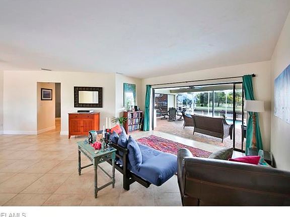 Living Room with view through sliders to Lanai