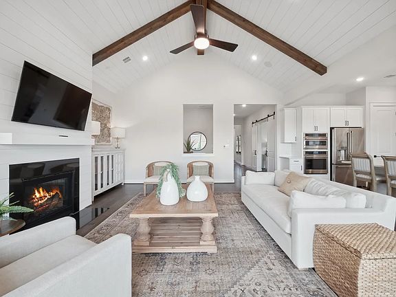 Great room with vaulted ceiling and stained ceiling beams