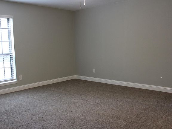 Primary bedroom at front of home is large with window providing natural light also has ceiling fan, fresh paint and premium carpet.