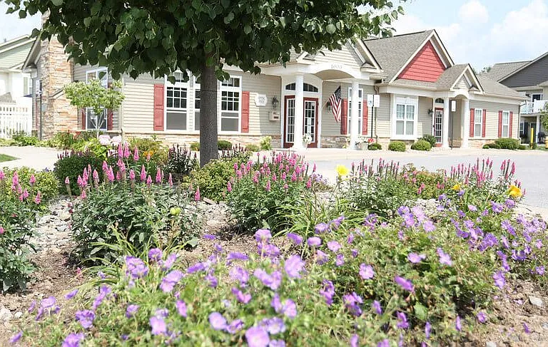 A flower bed in front of Leasing Office, Community Center, & Fitness Center building