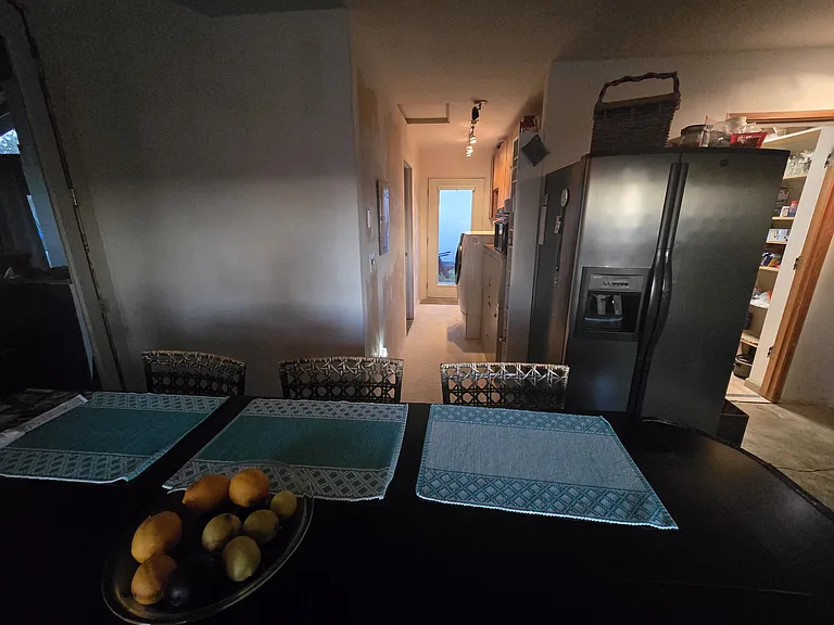 Hallway to laundry and bathroom. Outside door faces west.