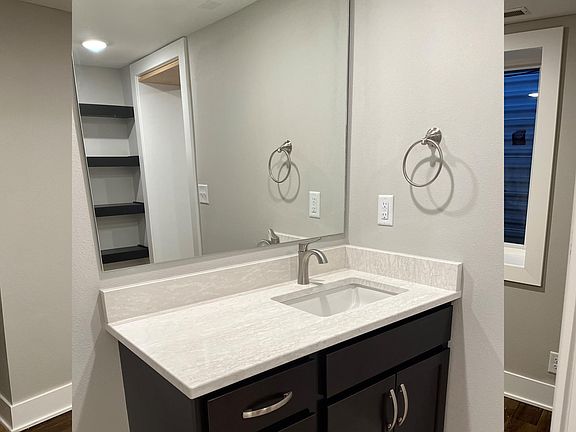Bathroom sink + mirror. Countertops are quartz.