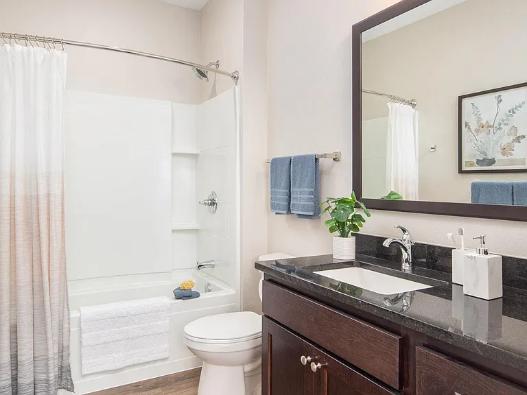 View of spacious, modern bathroom at The Whitley apartments.