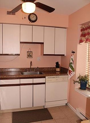 Kitchen has a tile floor, c...