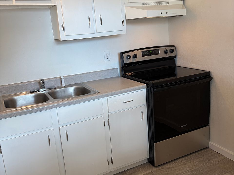 Kitchen with new stove, fixtures, and faucet