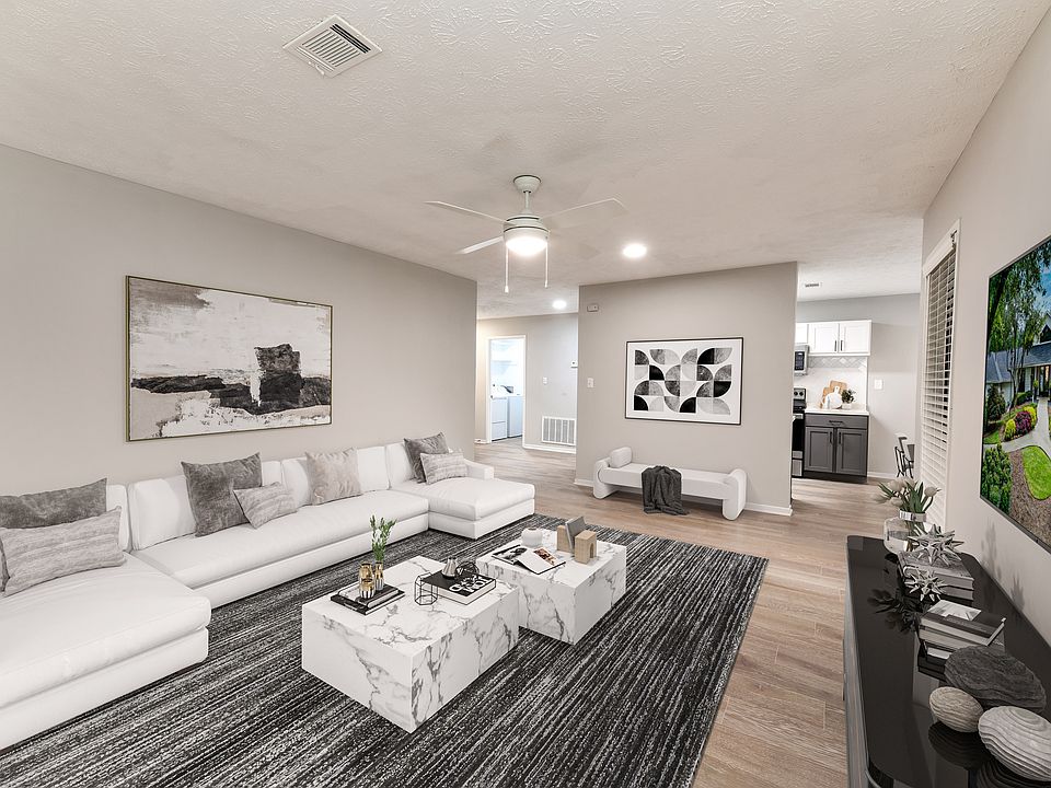 Large living area with wood-like floors
