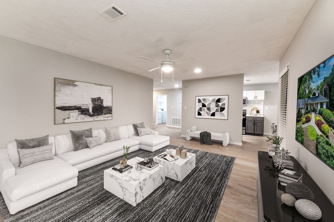 Large living area with wood-like floors